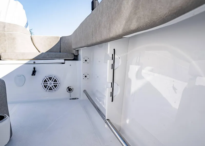 Slide: The Image of 2025 Sea Hunt Ultra 239 SE boat interior with seating and speaker system. - 19