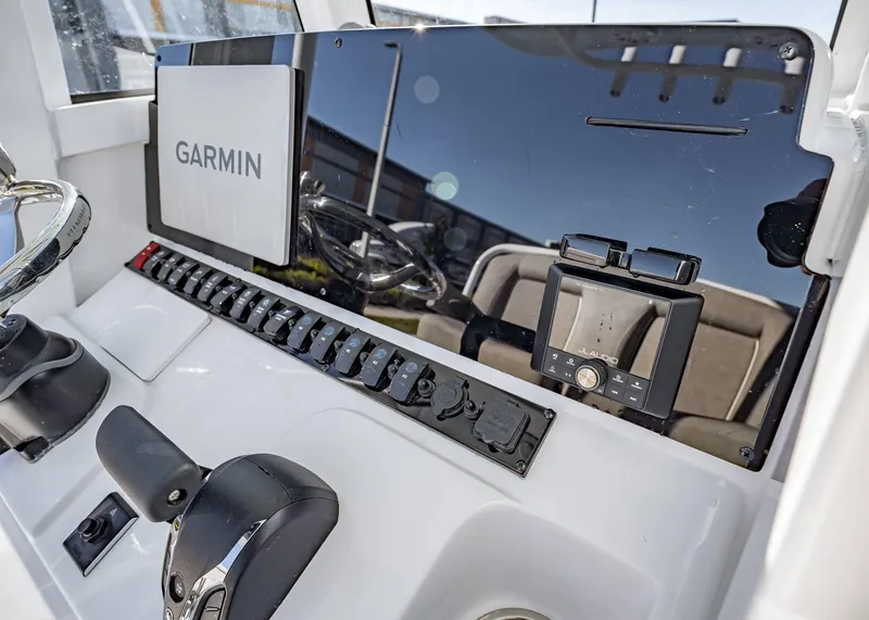 Slide: The Image of 2025 Sea Hunt Ultra 239 SE dashboard with Garmin and JL Audio systems. - 24