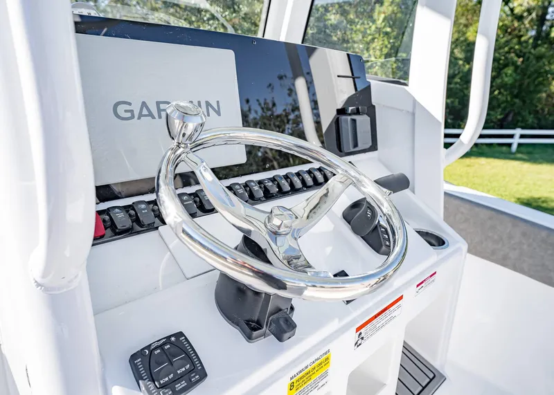 Slide: The Image of 2025 Sea Hunt Ultra 239 SE boat console with Garmin navigation system. - 28