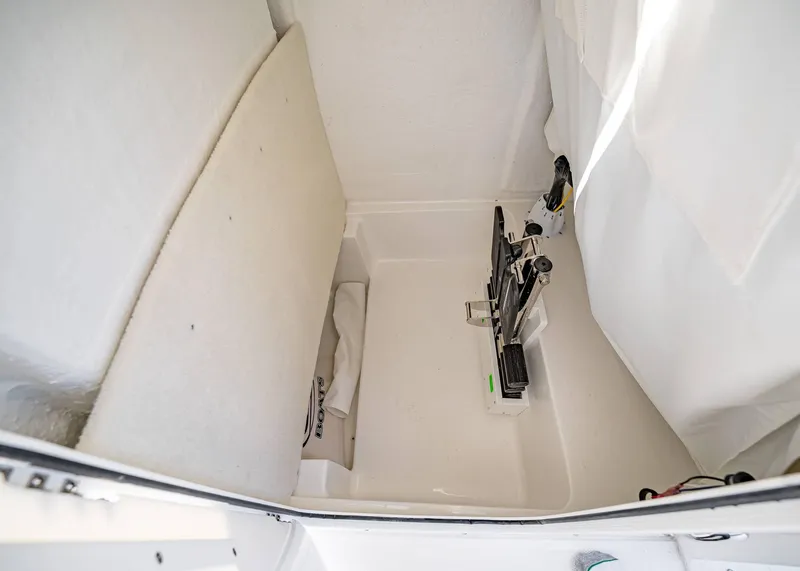Slide: The Image of 2025 Sea Hunt Ultra 239 SE interior storage compartment with clean, white finish. - 30