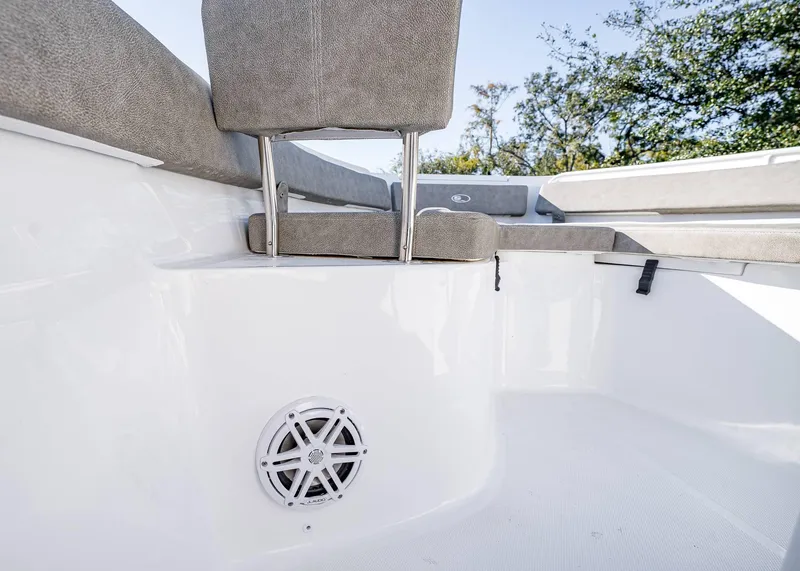 Slide: The Image of 2025 Sea Hunt Ultra 239 SE boat interior with cushioned seating and speaker. - 31