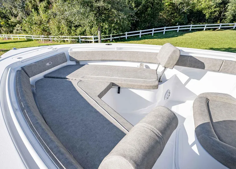 Slide: The Image of 2025 Sea Hunt Ultra 239 SE boat interior with cushioned seating and spacious layout. - 33