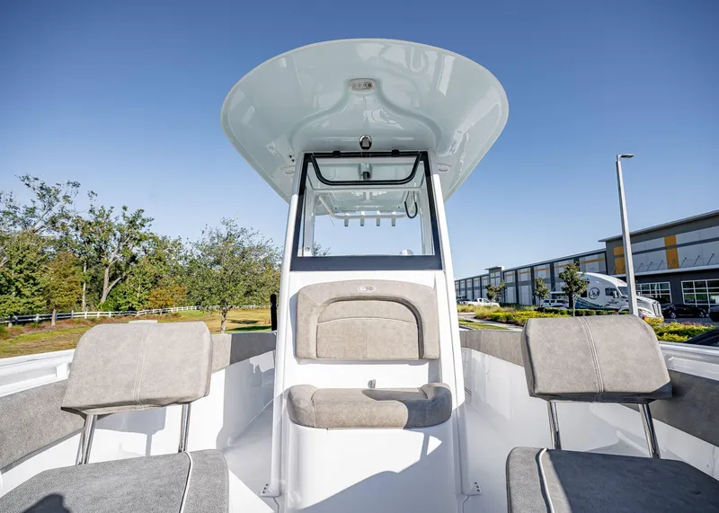 Slide: The Image of 2025 Sea Hunt Ultra 239 SE boat interior with seating and console, outdoors. - 36