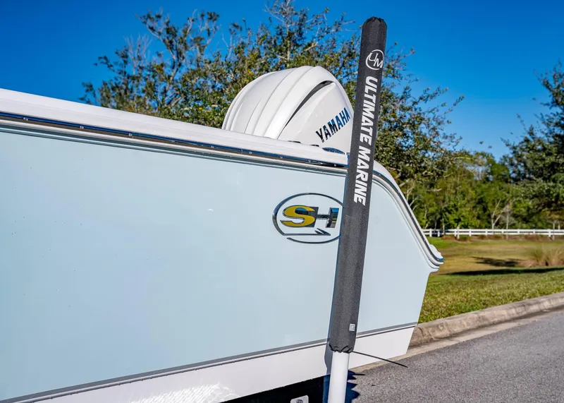 Slide: The Image of 2025 Sea Hunt Ultra 239 SE boat with Yamaha engine, parked outdoors. - 5