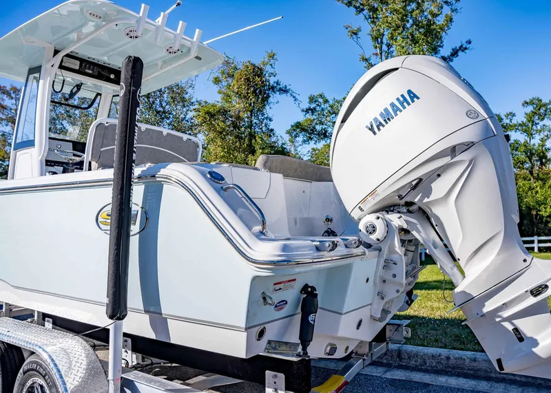 Slide: The Image of 2025 Sea Hunt Ultra 239 SE boat with Yamaha outboard engine on trailer. - 7