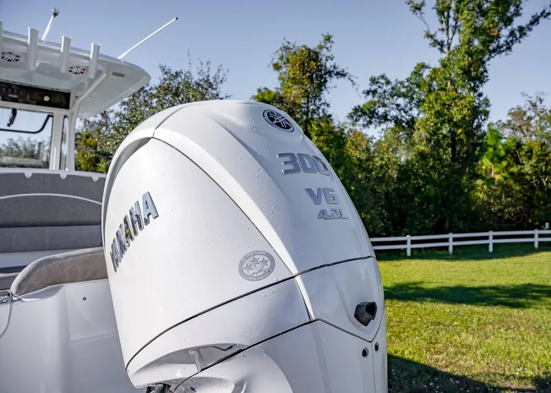 Slide: The Image of 2025 Sea Hunt Ultra 239 SE with Yamaha 300 V6 engine in a grassy area. - 8