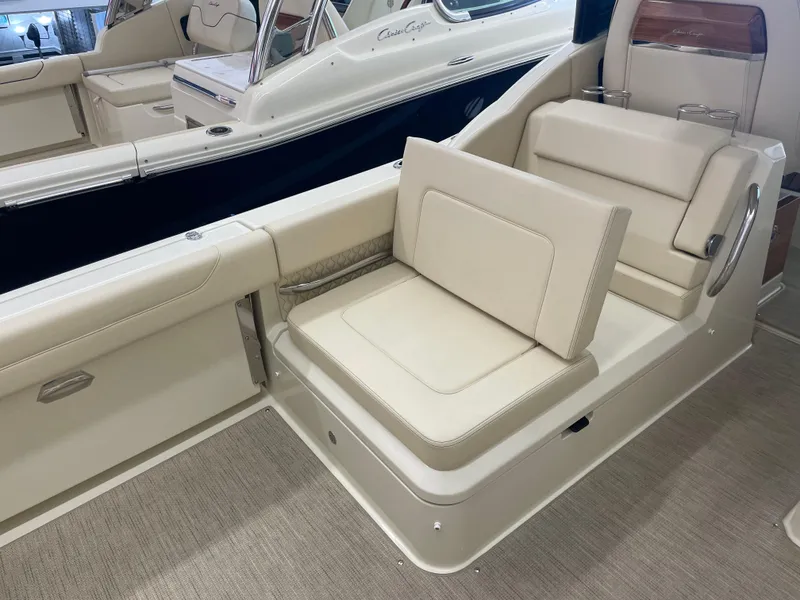 Slide: The Image of 2024 Chris-Craft Calypso 32 interior seating with beige upholstery and modern design. - 13