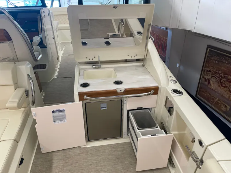 Slide: The Image of 2024 Chris-Craft Calypso 32 boat interior with kitchenette and storage compartments. - 15