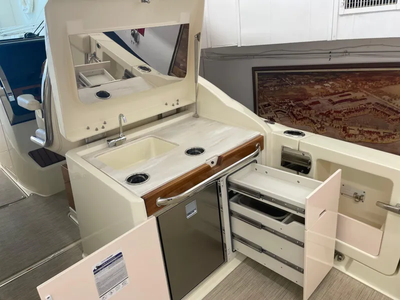 Slide: The Image of 2024 Chris-Craft Calypso 32 boat interior with kitchenette and storage drawers. - 16