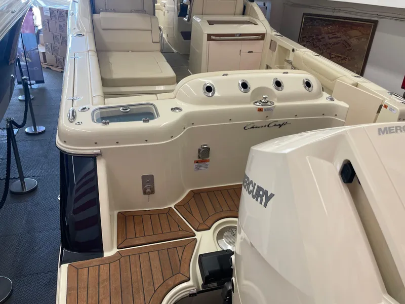 Slide: The Image of 2024 Chris-Craft Calypso 32 boat interior with Mercury engine, showcasing luxury design. - 2