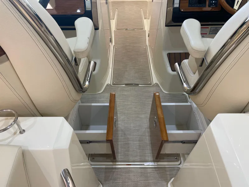 Slide: The Image of 2024 Chris-Craft Calypso 32 interior with open storage compartments and luxurious seating. - 20