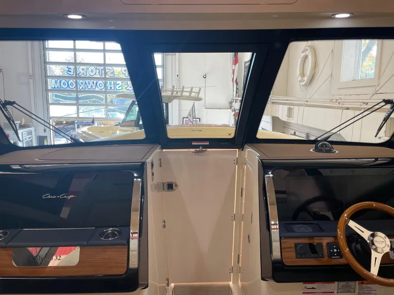 Slide: The Image of 2024 Chris-Craft Calypso 32 boat interior with modern dashboard and steering wheel. - 21