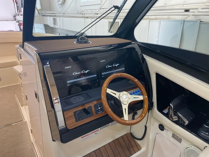 Slide: The Image of 2024 Chris-Craft Calypso 32 helm with modern controls and wooden steering wheel. - 22