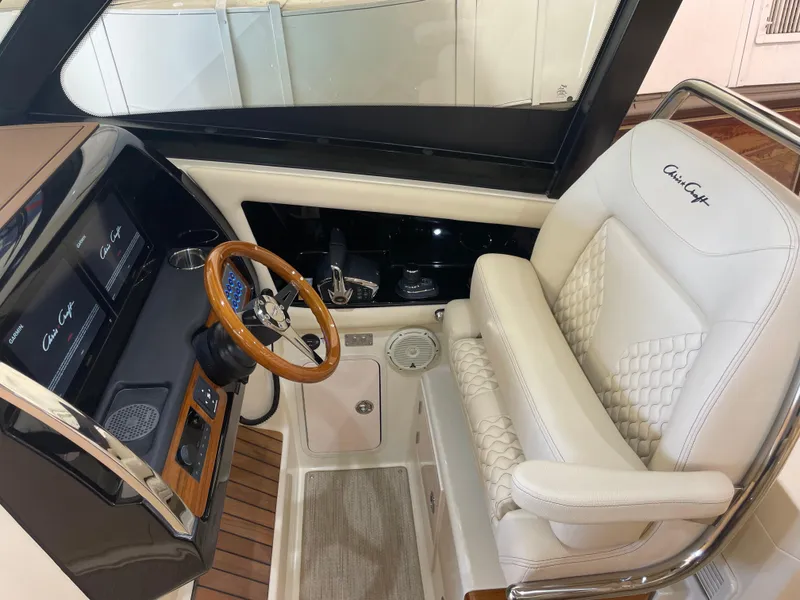 Slide: The Image of 2024 Chris-Craft Calypso 32 helm with luxury seating and wooden steering wheel. - 23