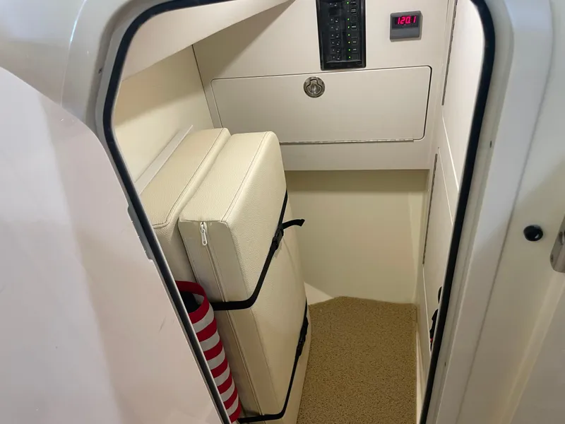 Slide: The Image of 2024 Chris-Craft Calypso 32 cabin interior with storage and control panel. - 31