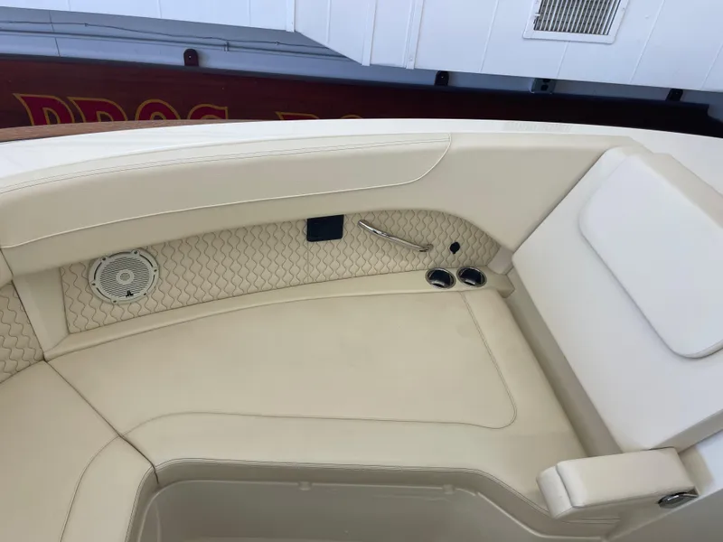 Slide: The Image of 2024 Chris-Craft Calypso 32 boat interior with beige seating and speaker detail. - 34