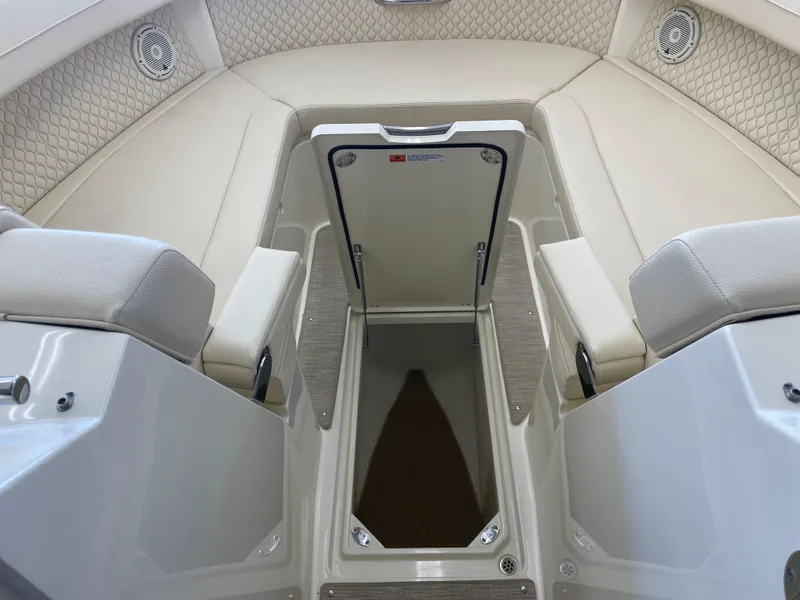 Slide: The Image of 2024 Chris-Craft Calypso 32 interior seating with storage compartment open. - 37