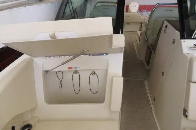 Slide: The Image of 2024 Chris-Craft Calypso 32 interior with open storage compartment. - 40