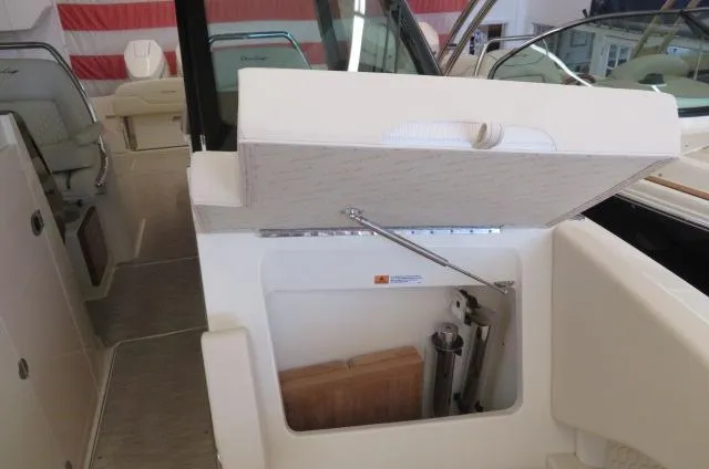 Slide: The Image of 2024 Chris-Craft Calypso 32 boat interior storage compartment with open lid. - 41