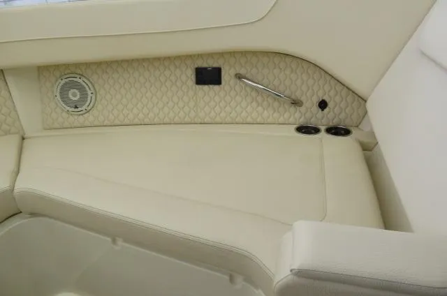 Slide: The Image of 2024 Chris-Craft Calypso 32 interior with beige seating and speaker detail. - 42