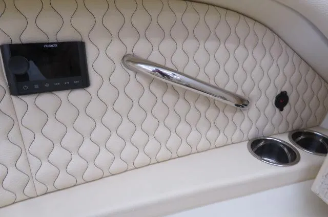 Slide: The Image of 2024 Chris-Craft Calypso 32 interior with quilted panel, chrome handle, and cup holders. - 45