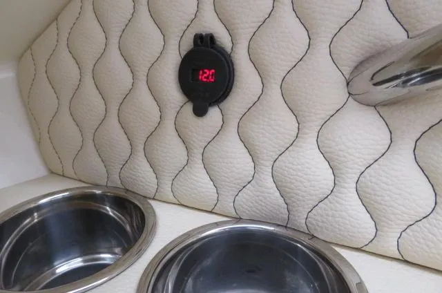 Slide: The Image of Chris-Craft Calypso 32 interior detail, 2024 model, featuring quilted upholstery and cup holders. - 47