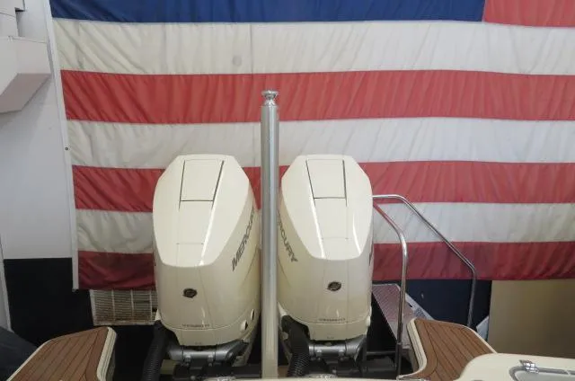 Slide: The Image of 2024 Chris-Craft Calypso 32 with dual Mercury outboard engines against American flag backdrop. - 6