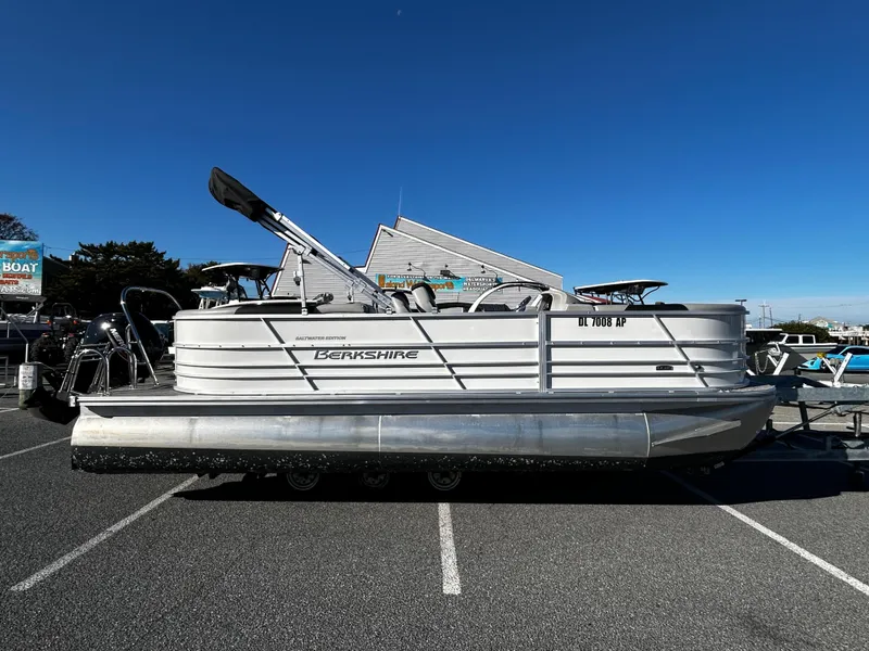 The Image of 2024 Berkshire 22RFX LE 2.75 pontoon boat parked in a lot under clear blue sky. - 0