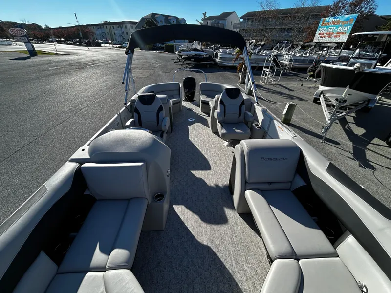 Slide: The Image of 2024 Berkshire 22RFX LE 2.75 pontoon boat with spacious seating and canopy in a marina. - 10