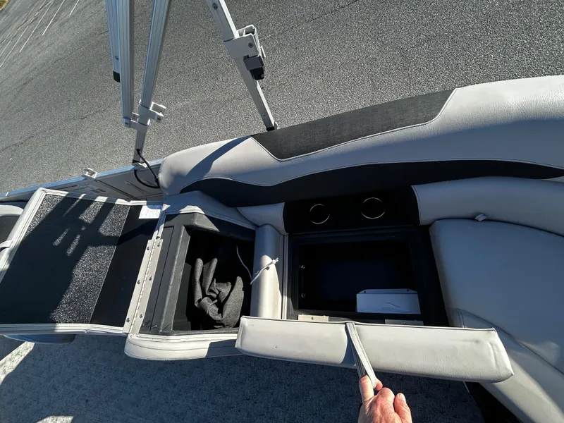 Slide: The Image of 2024 Berkshire 22RFX LE 2.75 boat interior with storage compartments and cup holders. - 16