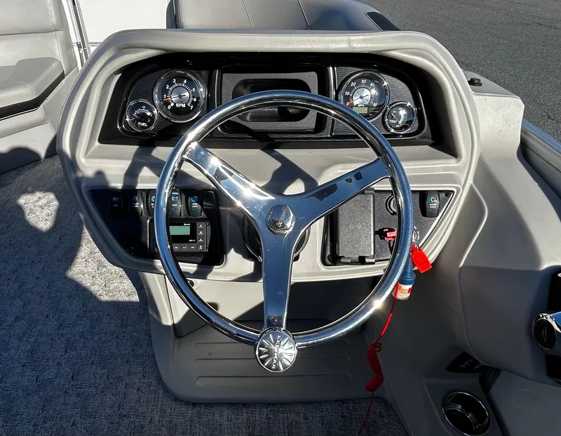 Slide: The Image of 2024 Berkshire 22RFX LE 2.75 boat steering wheel and dashboard controls. - 18