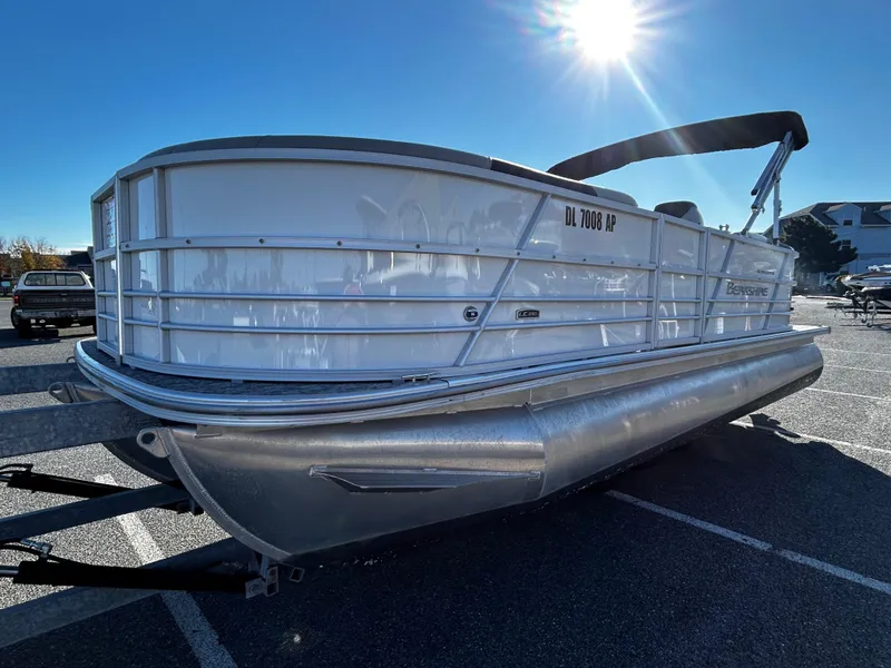 Slide: The Image of 2024 Berkshire 22RFX LE 2.75 pontoon boat in parking lot, sunny day. - 2
