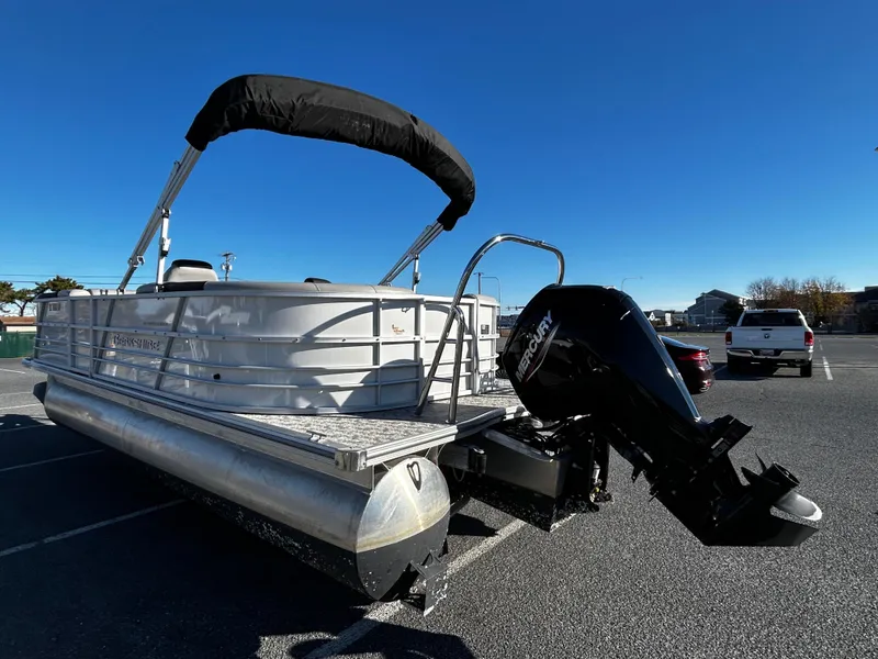 Slide: The Image of 2024 Berkshire 22RFX LE 2.75 pontoon boat with Mercury outboard motor in parking lot. - 4