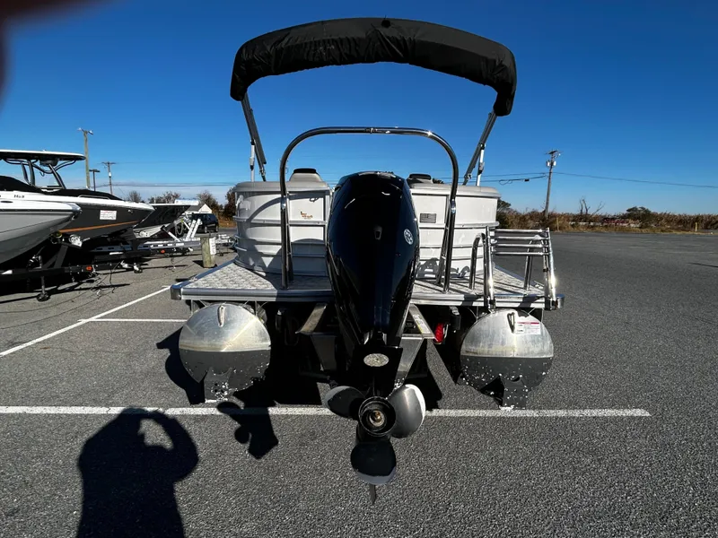 Slide: The Image of 2024 Berkshire 22RFX LE 2.75 pontoon boat with outboard motor in parking lot. - 5