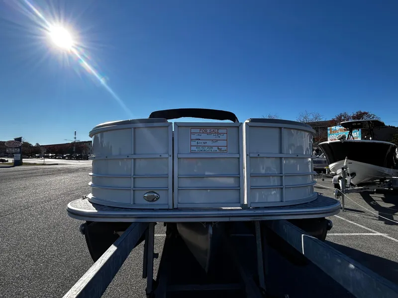 Slide: The Image of 2024 Berkshire 22RFX LE 2.75 pontoon boat under bright sun in parking lot. - 6