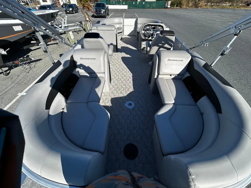 Slide: The Image of 2024 Berkshire 22RFX LE 2.75 pontoon boat interior with gray seating and steering console. - 7