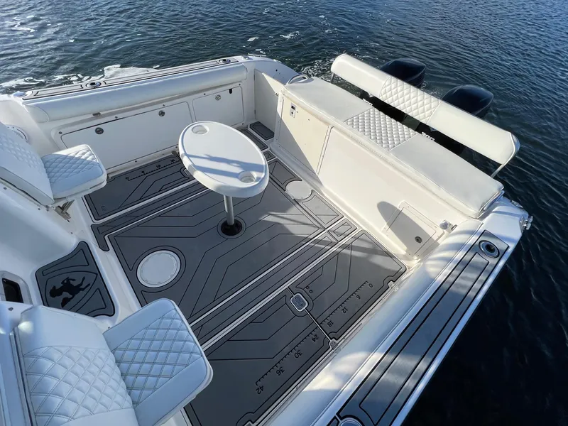 Slide: The Image of 2005 Century 3200 Walk-Around boat interior with seating and table on water. - 10