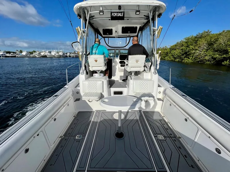 Slide: The Image of 2005 Century 3200 Walk-Around boat on water, two people seated, "For Sale" sign visible. - 11