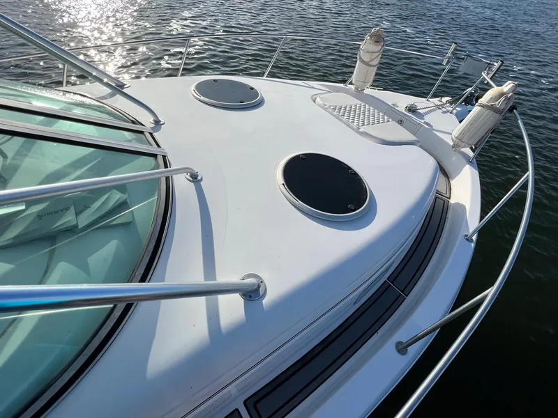 Slide: The Image of 2005 Century 3200 Walk-Around boat deck with railings on calm water. - 12