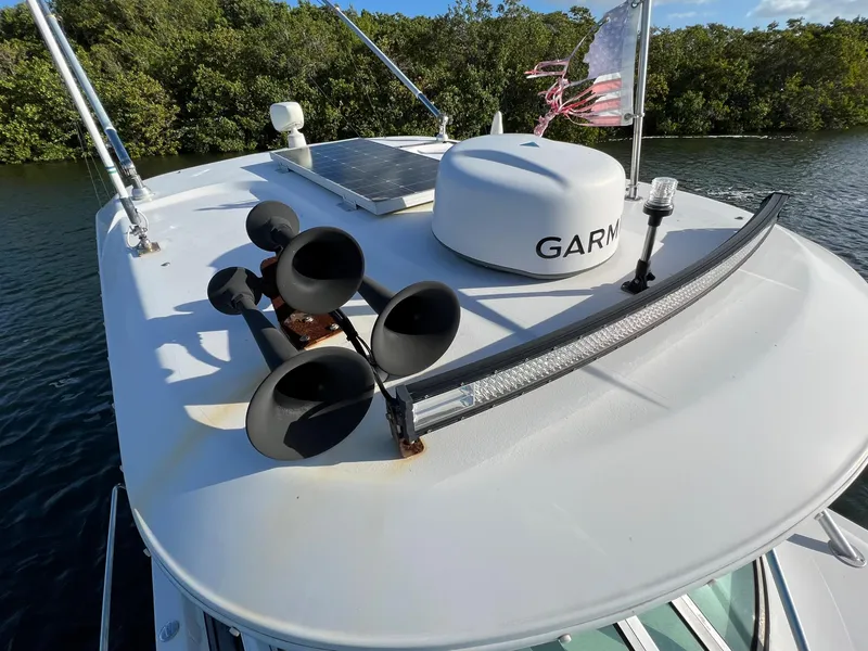 Slide: The Image of 2005 Century 3200 Walk-Around boat with radar and horns on deck. - 16