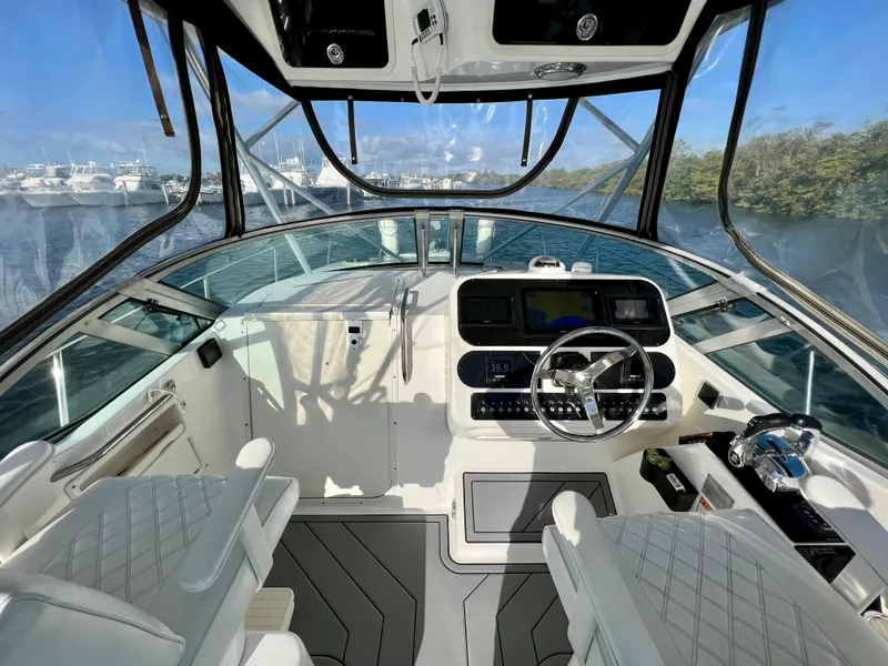 Slide: The Image of Interior view of 2005 Century 3200 Walk-Around boat with modern dashboard and seating. - 17