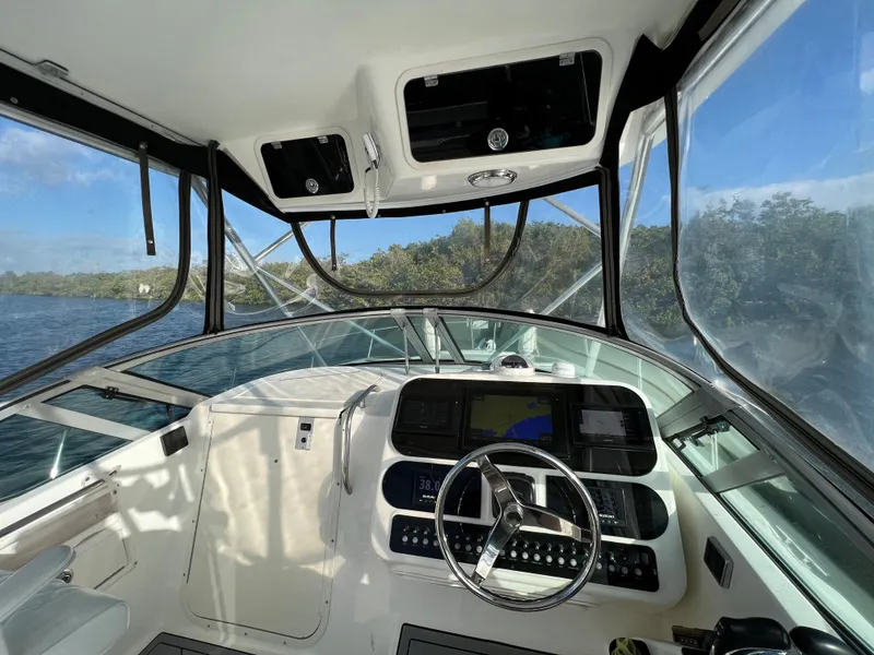 Slide: The Image of Interior view of 2005 Century 3200 Walk-Around boat cockpit with steering wheel. - 18