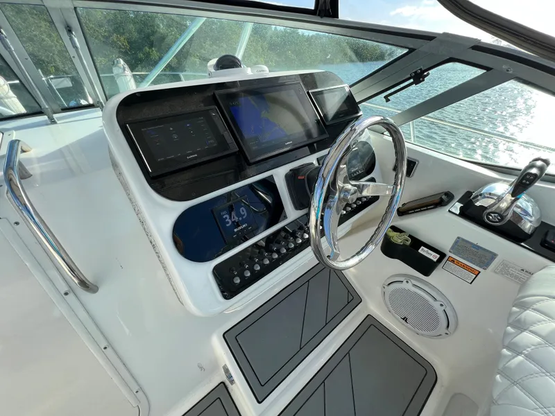 Slide: The Image of 2005 Century 3200 Walk-Around boat dashboard with steering wheel and navigation controls. - 20