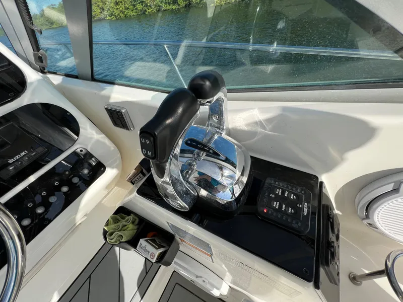 Slide: The Image of Century 3200 Walk-Around 2005 boat controls with throttle and navigation panel. - 24
