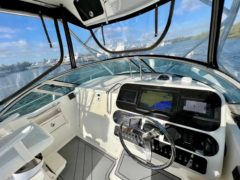 Slide: The Image of Century 3200 Walk-Around 2005 boat cockpit with navigation screens and steering wheel. - 26