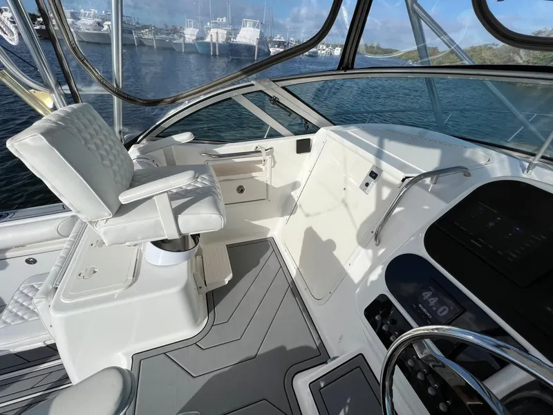 Slide: The Image of 2005 Century 3200 Walk-Around boat interior with helm and seating, docked at marina. - 27