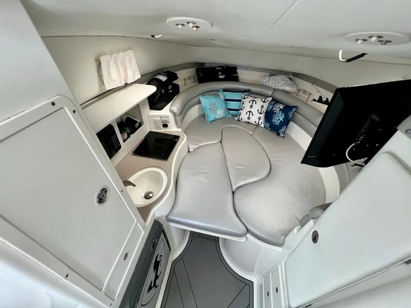 Slide: The Image of 2005 Century 3200 Walk-Around cabin interior with seating, sink, and TV. - 28