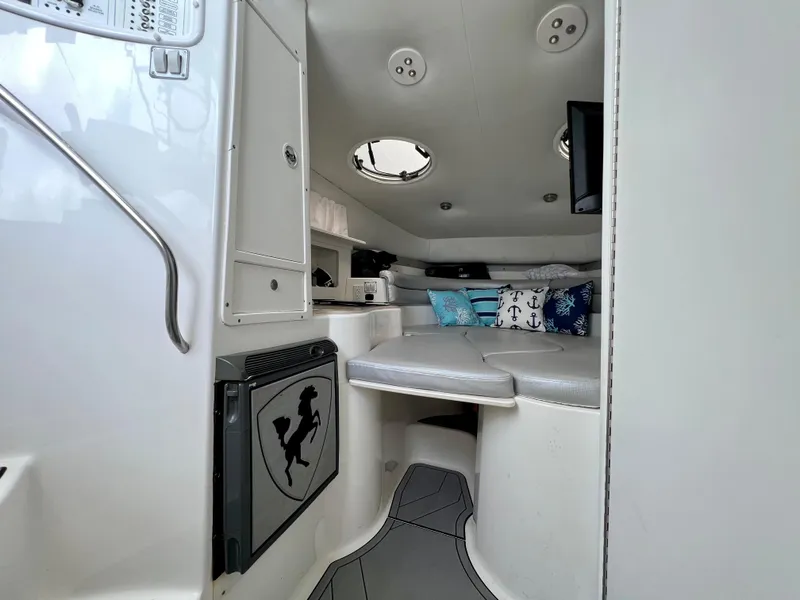 Slide: The Image of Interior of 2005 Century 3200 Walk-Around boat with cozy seating and nautical decor. - 31