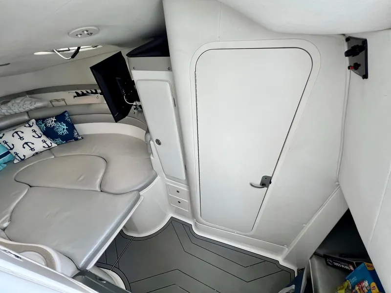 Slide: The Image of 2005 Century 3200 Walk-Around cabin interior with seating, TV, and nautical decor. - 33