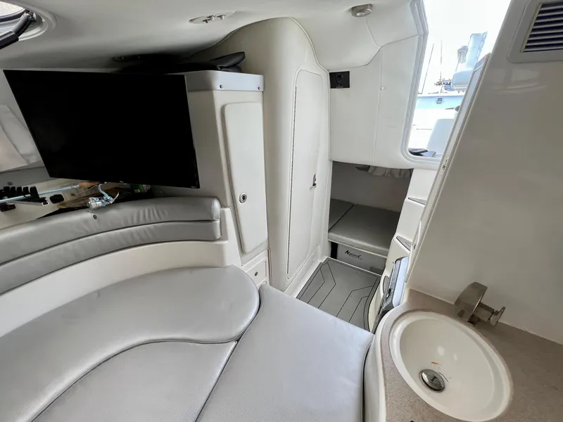 Slide: The Image of Interior of 2005 Century 3200 Walk-Around boat with seating, sink, and TV. - 37